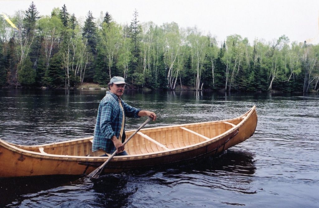 Tom paddling a canoe